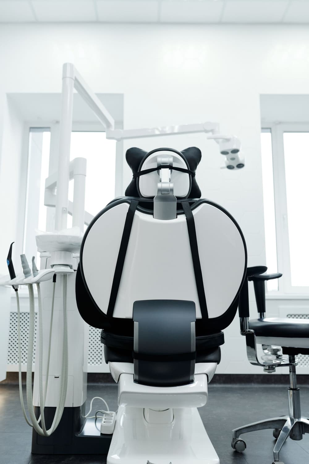 A bright treatment room with a blue dental chair